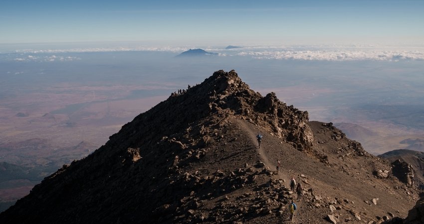 Touristen erkunden die Stadt mit einem lokalen Reiseleiter nach der Ankunft in Tansania Safari.